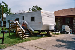 Regina and a neighbor on the front stoop of her FEMA trailer - Click for a larger image Regina and a neighbor on the front stoop of her FEMA trailer - Click for a larger image