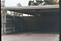 Oil "bathtub ring" on a carport wall in St. Bernard's Parish - Click for a larger image